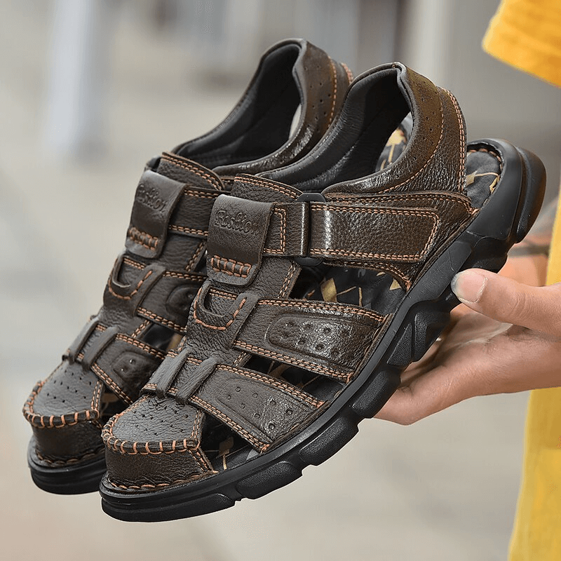 Soft Soles Genuine Leather Trekking Sandals with Anti-Collision Toes in hand, showcasing durable design and comfort.